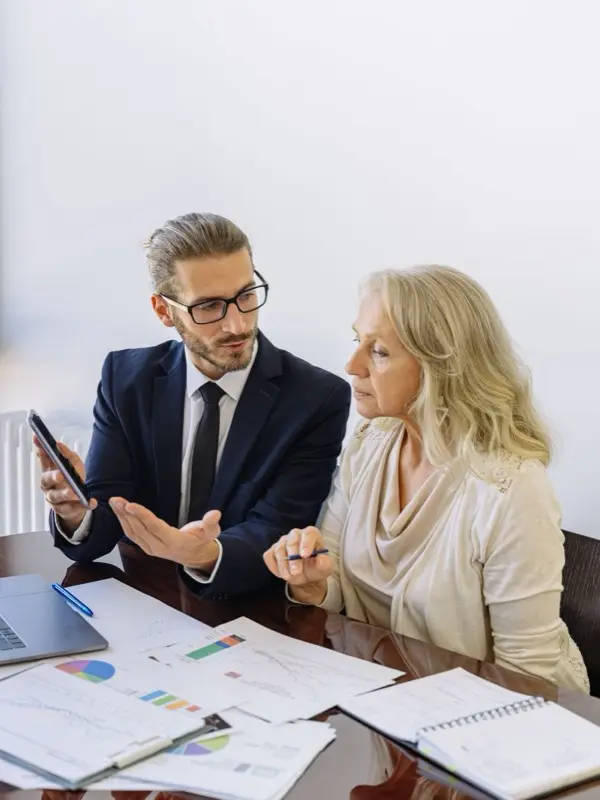 A consultant walking a client through materials at the desk